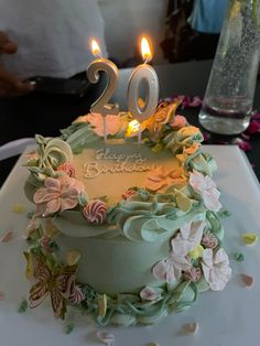 the birthday cake is decorated with flowers and candles