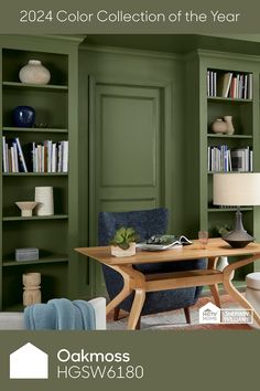 a living room with green walls and furniture in the center, along with bookshelves