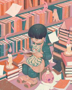 a young boy sitting in front of a pile of books and holding a cat on his lap