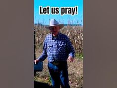 an old man wearing a cowboy hat and holding a box in front of a field