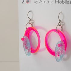 Dazzling NEON fluorescent hot pink and sparkly blue earrings. Delightful groovy 1960s / 1970s retro mod style. Modern statement earrings. NOTE: height size is measured from the top of the ear wire. Custom handmade by me in my Los Angeles studio. These colorful earrings feature no-worry, no-pain hypo-allergenic titanium ear wire, stainless steel rings, adorably mod acrylic dangle shapes, and silicone backs. All materials made in the USA. Arrives in cool black and white gift box. FREE SHIPPING IN Retro Pink Earrings For Party, Retro Pink Party Earrings, Pink Plastic Drop Earrings, Retro Blue Party Earrings, Funky Pink Jewelry For Party, Retro Pink Drop Earrings, Pink Plastic Earrings For Party, Pink Plastic Party Earrings, Handmade Retro Pink Earrings