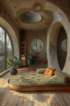 a bed sitting in the middle of a room next to two round windows and a desk