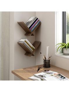 three bookshelves on the wall above a desk