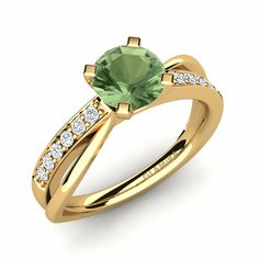 a gold ring with a green stone and diamonds on the side, set in 18k yellow gold