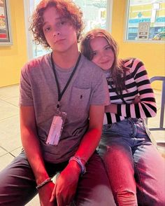 a young man and woman sitting next to each other