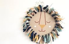 a wall clock with a lion face on it's face made out of fabric