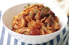 a white bowl filled with pasta covered in sauce