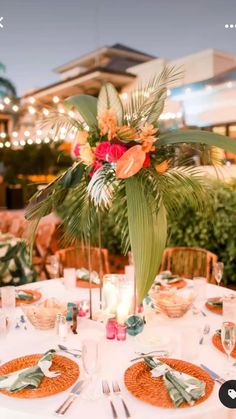 the table is set with plates and place settings