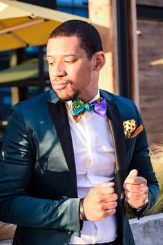 A traditional selftie bowtie made with multicolored African fabric. The neck length goes from 15-18 inches, with total length going up to 36 inches. If you have questions or want more information about this savvy bowtie or bulk ordering for any event, please feel free to make contact and we'll be happy to help! Dry clean only. Please note that there may be factors that could affect the perceived color of an item. Also, due to different patters and cuts on the fabric, each bow tie made may look s Dapper Tuxedo With Ties For Groom, Fitted Ties With Pocket Square For Black-tie Events, Dapper Semi-formal Ties With Satin Bow, Dapper Wedding Tuxedo With Ties, Fitted Party Suit And Tie Accessories With Decorative Bow, Dapper Satin Bow Tie, Dapper Ties With Pocket Square For Black Tie Events, Dapper Fitted Standard Tie Bow, Multicolor Accessories For Black Tie Events