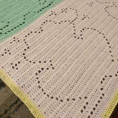 a crocheted blanket sitting on top of a wooden table