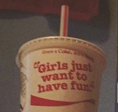 a paper cup with a straw in it that says girls just want to have fun