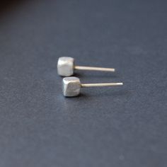 These small mens studs are perfect minimalist stud earrings for men. The geometric studs are in a form of a cube with rounded edges. Their form was inspired by the pebbles in the beach shaped by the sea waves.  These earrings come in brushed finish - rough surface finish that contrasts with soft form. The earrings are made of solid sterling silver with included earnuts.  The size of the studs are 0.5 cm (0.2 in). To see other minimalist studs from my shop please visit  https://www.etsy.com/shop/ Mens Studs, Mens Stud Earrings, Mens Silver Earrings, Earrings Mens, Artistic Earrings, Minimalist Stud Earrings, Geometric Statement Earrings, Stud Earrings For Men, Geometric Hoop Earrings