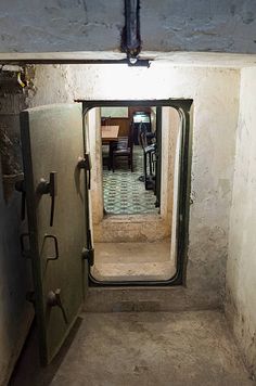 an open door leading into a room with a tiled floor and walls on both sides