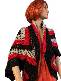 a mannequin wearing a red and black crocheted jacket