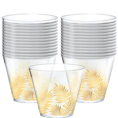 a stack of clear cups with yellow leaves on the side and white rims around them