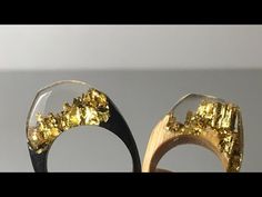 a pair of wooden and glass rings with gold flakes on it's sides