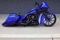 a blue motorcycle is parked on the sidewalk