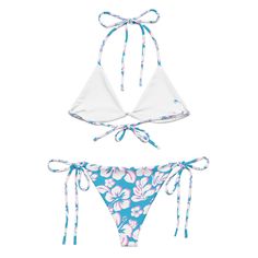 Indulge in the luxurious and exclusive style of our White, Aqua Blue and Pink Hawaiian Flowers String Bikini. This beautiful string bikini set is not only comfortable, but it also offers double-layering and UPF 50+ protection. Customize the straps to your liking and get ready to turn heads at the beach! Made from soft recycled polyester, this bikini is both stylish and sustainable.• Soft and stretchy material with UPF 50+• Sizes up to 6XL• Bikini top comes with removable padding for comfort• Mul Hibiscus Flower Bikinis, Blue String Swimwear For Swimming, Blue String Beachwear Swimwear, Blue String Swimwear For Beach, Blue String Swimwear For Beachwear, Blue String Swimwear For Vacation, Pink Hawaiian Flowers, Blue Hibiscus, White Bikinis