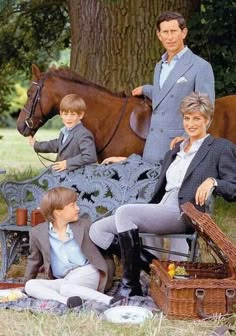 three people sitting on a bench in front of a horse and two children standing next to it