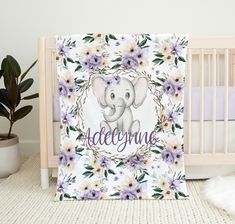 a baby crib with an elephant and flowers on it