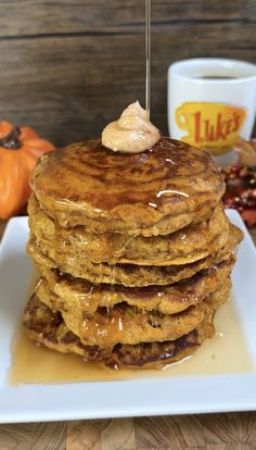 a stack of pancakes on a white plate