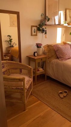 a bed sitting in a bedroom next to a wooden table and chair on top of a hard wood floor