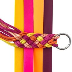 an orange, pink, and yellow bracelet with a metal hook