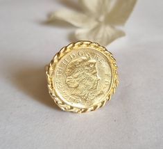 Gold coin ring, coin pinky ring, gold signet ring, coin signet ring, cocktail ring vintage style coin ring, vintage gold ring, pinky ring This gold coin ring is made of a British 5p coin which was decorated with braided gold filled wires and attached to a wide handmade band, creating a lovely signet ring. The coin coin ring is designed in a vintage style and is available both in 14k gold plating over brass or silver as well as sterling silver (see last photo). The ring is a great cocktail ring a Vintage Engraved Coin Signet Ring, Vintage Coin Signet Ring As Gift, Vintage Coin Shaped Signet Ring Gift, Vintage Coin Signet Ring For Gift, Gold Coin-shaped Engraved Signet Ring, Gold Engraved Coin Signet Ring, Vintage 14k Gold Coin Ring, Hallmarked Coin Shaped Signet Ring As Gift, Gold Coin-shaped Signet Ring For Gift