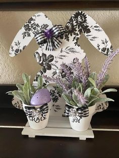 an easter bunny decoration made out of egg shells and lavenders with the word joy painted on it