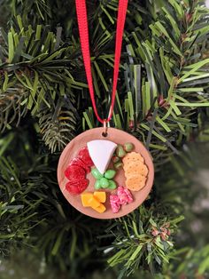 an ornament hanging from a christmas tree with candy and crackers on it