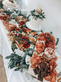 a buffet table filled with lots of different types of foods and desserts on it