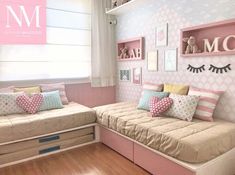 a bedroom with pink and white decor on the walls