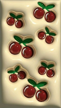 the cookies are shaped like cherries with green leaves