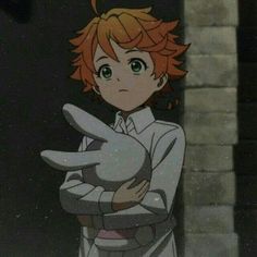 an anime character with red hair and green eyes holding a stuffed animal in his arms