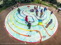 an aerial view of people standing around a colorful circle