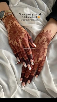 a woman's hands with henna on it