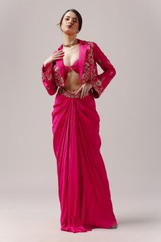 Fuchsia pink jacket with floral embroidery, embellished with bead work. Paired with a draped skirt with an embroidered belted waistline and bustier. - Aza Fashions Hand Embellished Long Sleeve Fitted Choli, Hand Embellished Fitted Long Sleeve Choli, Fitted Hand Embellished Festive Outerwear, Silk Long Sleeve Choli For Parties, Elegant Pink Outerwear For Festive Occasions, Elegant Pink Festive Outerwear, Pink Festive Outerwear For Wedding, Fitted Long Sleeve Jacket Dress For Festive Occasions, Pink Wedding Outerwear