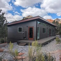 a tiny house sits in the middle of a rocky area