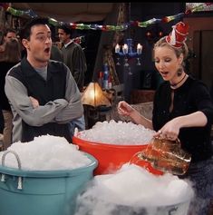 a man and woman standing in front of buckets filled with ice