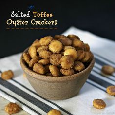 salted toffee oyster crackers in a small bowl on a striped napkin