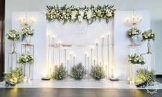 a wedding stage decorated with flowers and candles