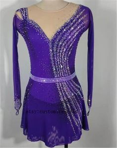 a purple figure skating dress with sequins on it