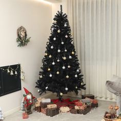 a decorated christmas tree in the corner of a living room with presents on the floor