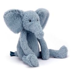 an elephant stuffed animal sitting on the ground