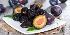 plums and raisins on a white plate