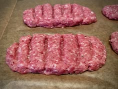 raw hamburger patties on a baking sheet ready to be cooked