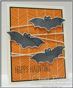 an orange and black card with bats on it