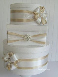 three tiered wedding cake with bows on top