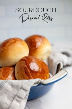 some bread rolls are in a blue bowl