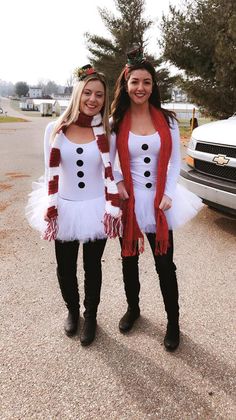 two women dressed in costumes standing next to each other